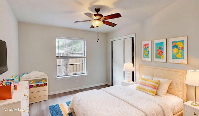 6916 Moccasin Dr, Plano, TX 75023 - bedroom with wood finished floors, a closet, baseboards, and ceiling fan