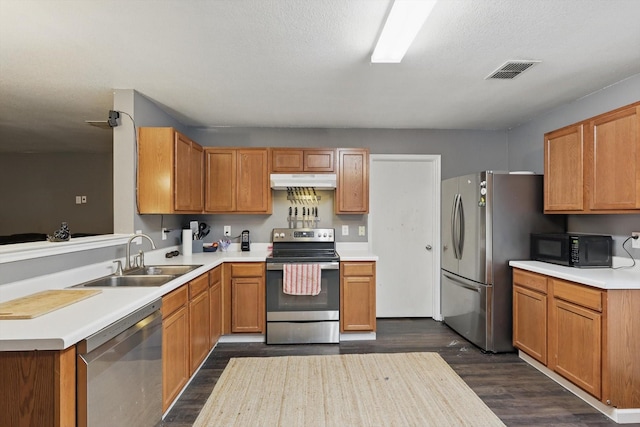 848 Cats Eye Dr, Fort Worth, TX 76179 - kitchen with stainless steel appliances, a sink, dark wood-style flooring, under cabinet range hood, and light countertops