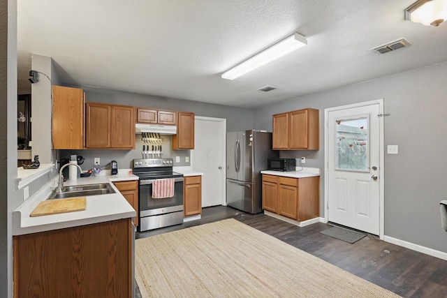 848 Cats Eye Dr, Fort Worth, TX 76179 - kitchen with stainless steel appliances, a sink, under cabinet range hood, dark wood finished floors, and light countertops