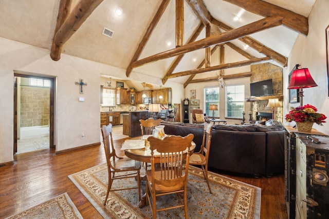 222 Bayne Rd, Haslet, TX 76052 - dining room featuring beam ceiling, healthy amount of natural light, wood finished floors, a fireplace, and high vaulted ceiling