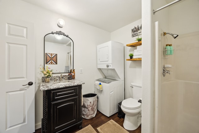222 Bayne Rd, Haslet, TX 76052 - bathroom featuring estacked washer and dryer, a shower with shower curtain, wood finished floors, vanity, and toilet