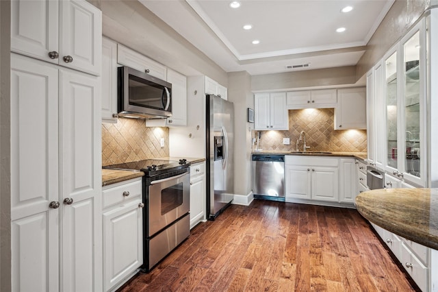 5200 Keller Springs Rd Unit 330, Dallas, TX 75248 - kitchen featuring appliances with stainless steel finishes, a sink, white cabinetry, dark wood finished floors, and recessed lighting