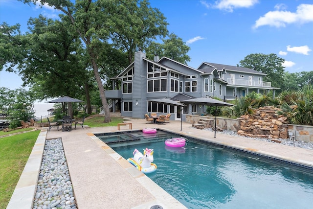 125 Oak Creek Dr, Tool, TX 75143 - view of swimming pool with outdoor dining area, a patio, and a pool with connected hot tub
