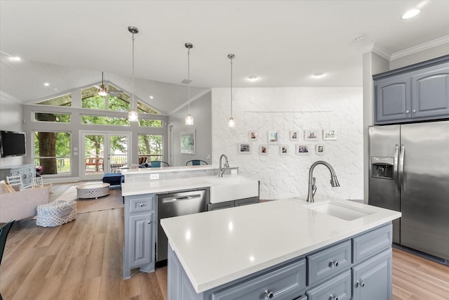 125 Oak Creek Dr, Tool, TX 75143 - kitchen featuring appliances with stainless steel finishes, a sink, open floor plan, gray cabinets, and vaulted ceiling
