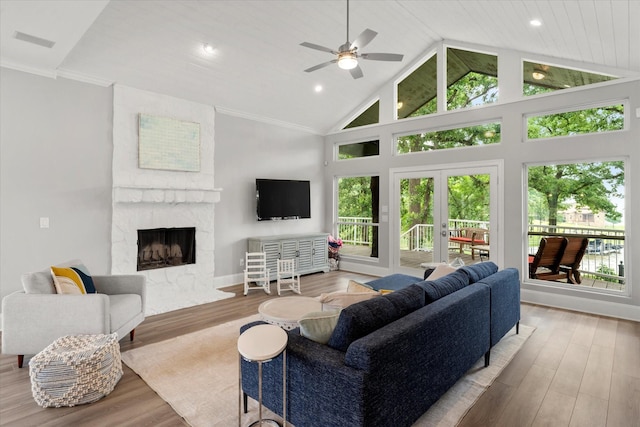 125 Oak Creek Dr, Tool, TX 75143 - living room with a large fireplace, wood finished floors, healthy amount of natural light, high vaulted ceiling, and recessed lighting