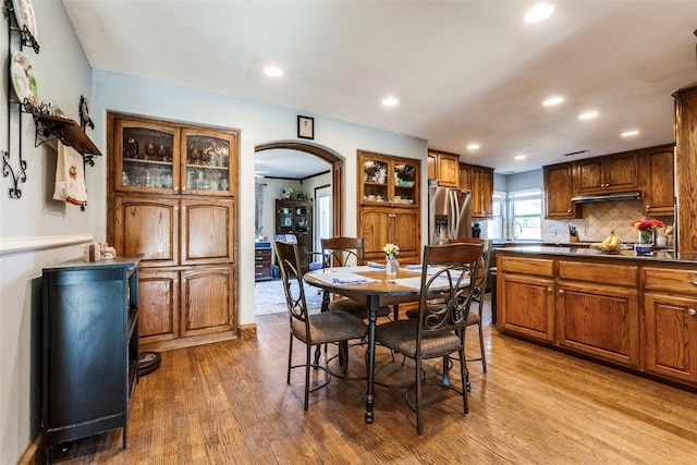 5301 Calumet Dr, Plano, TX 75023 - dining room featuring arched walkways, wood finished floors, and recessed lighting