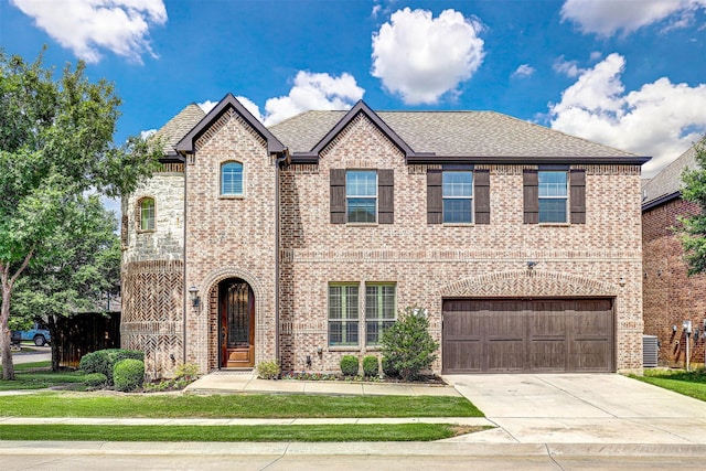 7205 E Nirvana Cir, North Richland Hills, TX 76182 - view of front of home featuring brick siding, concrete driveway, and an attached garage