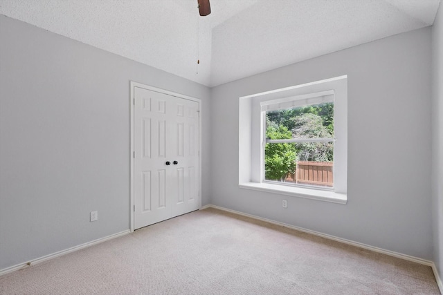 2308 Grandview Dr, Flower Mound, TX 75028 - unfurnished bedroom with light carpet, a closet, baseboards, and lofted ceiling