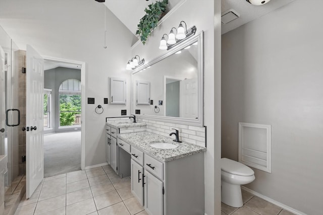 2308 Grandview Dr, Flower Mound, TX 75028 - full bathroom featuring double vanity, tile patterned flooring, a shower stall, toilet, and backsplash