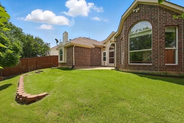 2308 Grandview Dr, Flower Mound, TX 75028 - rear view of house with brick siding, a chimney, and a patio area