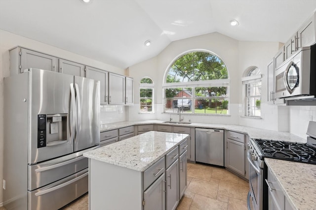 2308 Grandview Dr, Flower Mound, TX 75028 - kitchen with appliances with stainless steel finishes, gray cabinets, a sink, vaulted ceiling, and plenty of natural light