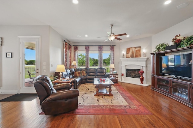 8913 Honeysuckle Dr, Lantana, TX 76226 - living room with a glass covered fireplace, healthy amount of natural light, recessed lighting, wood finished floors, and ceiling fan