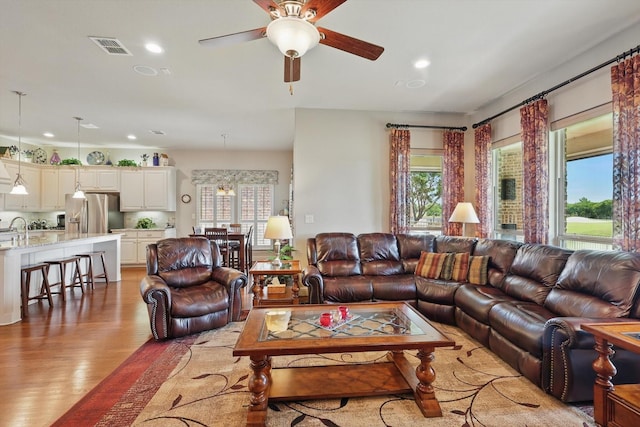 8913 Honeysuckle Dr, Lantana, TX 76226 - living area with plenty of natural light, light wood finished floors, recessed lighting, and a ceiling fan