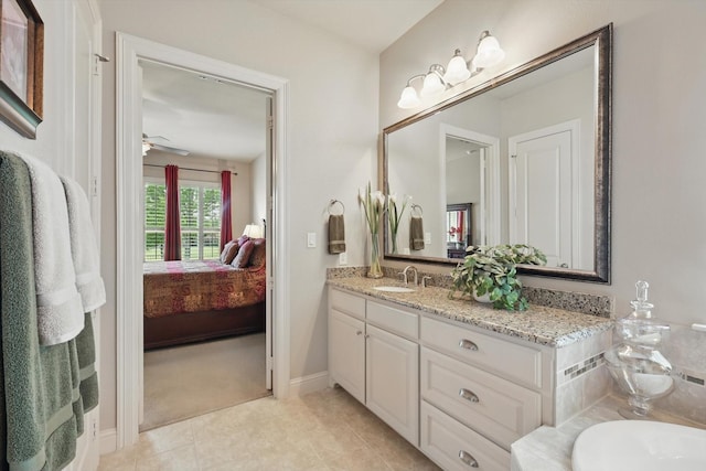 8913 Honeysuckle Dr, Lantana, TX 76226 - bathroom with vanity, ensuite bathroom, a ceiling fan, tile patterned floors, and baseboards