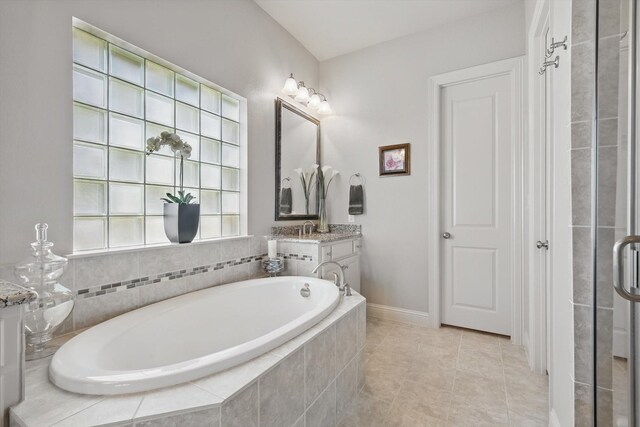 8913 Honeysuckle Dr, Lantana, TX 76226 - full bath with vanity, a bath, tile patterned floors, and baseboards