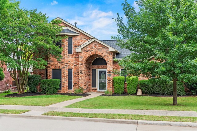 807 Fall Dr, Allen, TX 75002 - traditional home with brick siding, a shingled roof, and a front yard