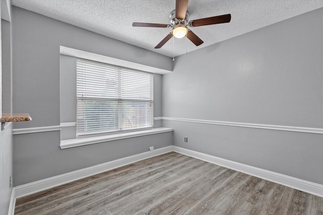 807 Fall Dr, Allen, TX 75002 - unfurnished room with a ceiling fan, a textured ceiling, wood finished floors, and baseboards