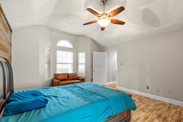 807 Fall Dr, Allen, TX 75002 - bedroom with vaulted ceiling, light wood-type flooring, a textured ceiling, baseboards, and ceiling fan