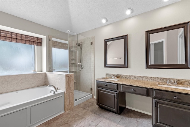 807 Fall Dr, Allen, TX 75002 - full bath featuring a stall shower, a garden tub, double vanity, a textured ceiling, and tile patterned floors