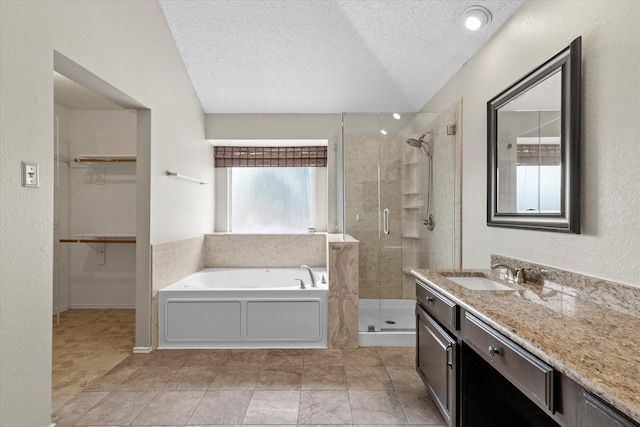 807 Fall Dr, Allen, TX 75002 - bathroom with a shower stall, a bath, a textured ceiling, vanity, and a spacious closet