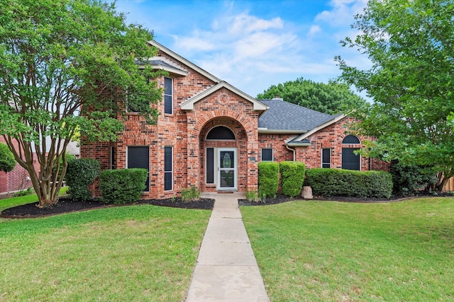 807 Fall Dr, Allen, TX 75002 - traditional-style house with brick siding, a front yard, and roof with shingles