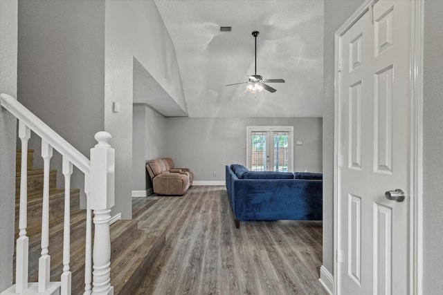 807 Fall Dr, Allen, TX 75002 - living area featuring ceiling fan, wood finished floors, vaulted ceiling, baseboards, and stairs
