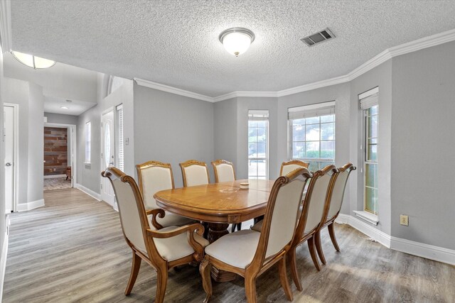 807 Fall Dr, Allen, TX 75002 - dining area with light wood-style flooring, a textured ceiling, baseboards, and crown molding