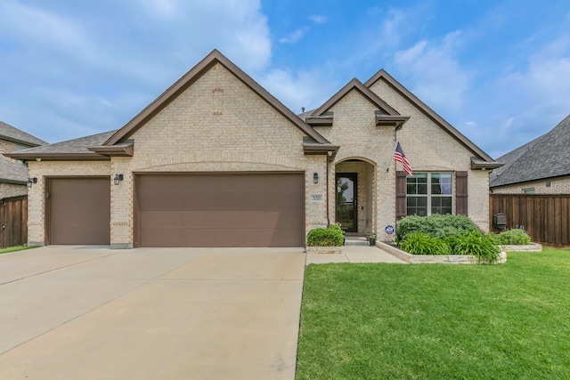 320 Lake Trail Ln, Prosper, TX 75078 - french country home featuring brick siding, concrete driveway, a garage, and a shingled roof