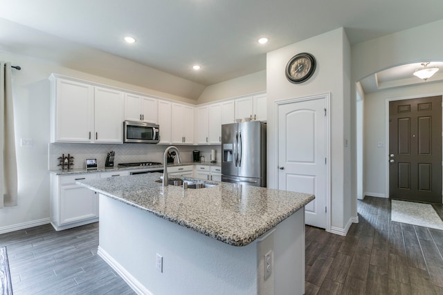 320 Lake Trail Ln, Prosper, TX 75078 - kitchen with stainless steel appliances, a sink, arched walkways, dark wood-style floors, and recessed lighting