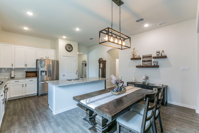 320 Lake Trail Ln, Prosper, TX 75078 - dining room featuring arched walkways, dark wood-style flooring, recessed lighting, and baseboards