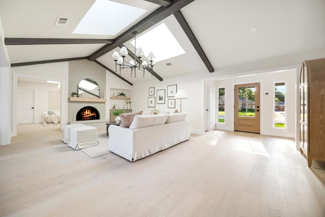 7117 La Sobrina Dr, Dallas, TX 75248 - living room with a skylight, a chandelier, light wood-style flooring, and a fireplace