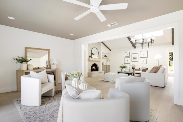 7117 La Sobrina Dr, Dallas, TX 75248 - living area with light wood-style flooring, a chandelier, a fireplace, vaulted ceiling, and a ceiling fan