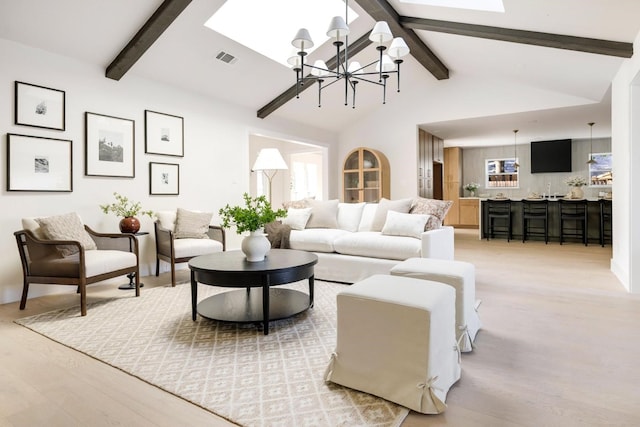 7117 La Sobrina Dr, Dallas, TX 75248 - living room featuring a chandelier, light wood-type flooring, a skylight, and plenty of natural light