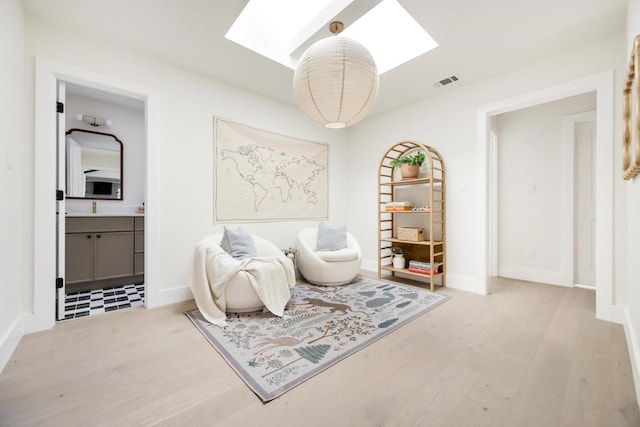7117 La Sobrina Dr, Dallas, TX 75248 - living area with a skylight and wood finished floors