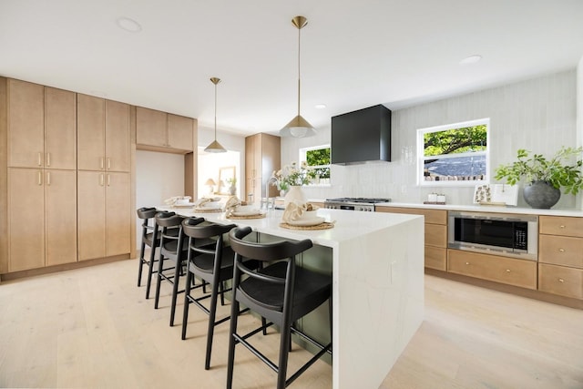 7117 La Sobrina Dr, Dallas, TX 75248 - kitchen with stainless steel microwave, range hood, light wood-style floors, light brown cabinets, and recessed lighting