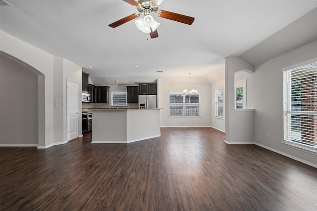 205 Mount Olive Ave, Mckinney, TX 75072 - unfurnished living room featuring healthy amount of natural light, a chandelier, dark wood finished floors, and baseboards