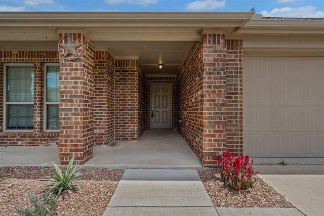 205 Mount Olive Ave, Mckinney, TX 75072 - doorway to property featuring brick siding and an attached garage