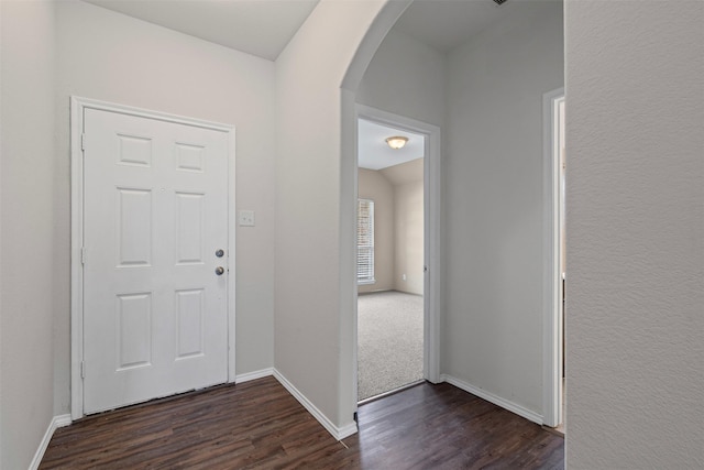 205 Mount Olive Ave, Mckinney, TX 75072 - foyer featuring arched walkways, dark wood-style floors, and baseboards
