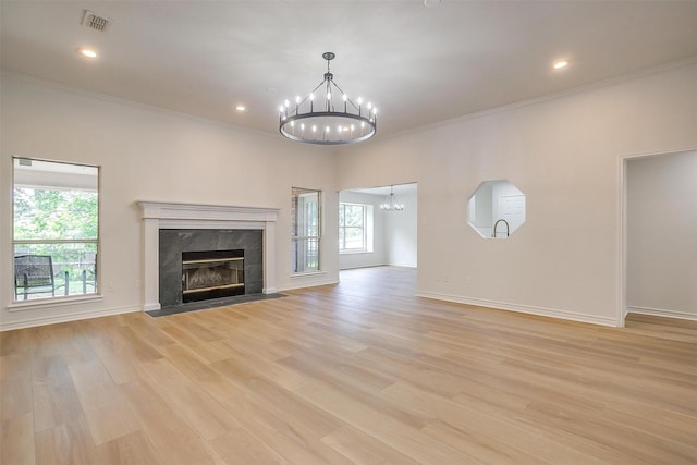 1177 Little Stone Ln, Burleson, TX 76028 - unfurnished living room featuring a chandelier, a high end fireplace, crown molding, light wood-style floors, and baseboards