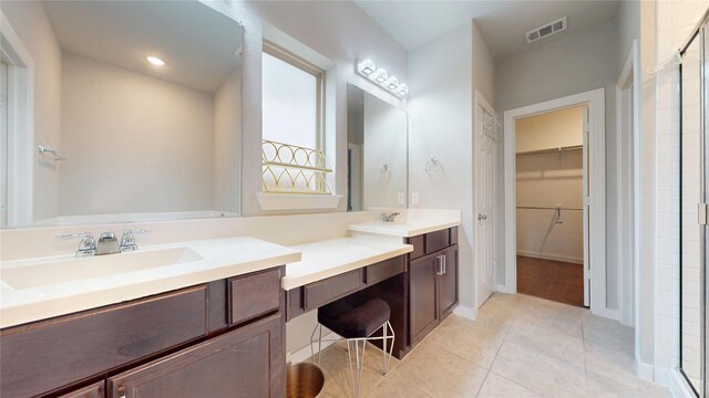 1916 Prestige Cove Ct, Wylie, TX 75098 - bathroom with double vanity, a walk in closet, a shower stall, tile patterned flooring, and recessed lighting