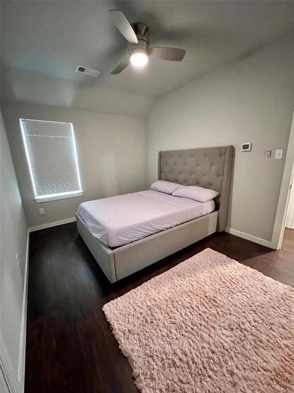 1916 Prestige Cove Ct, Wylie, TX 75098 - bedroom with dark wood-style flooring, baseboards, vaulted ceiling, and ceiling fan