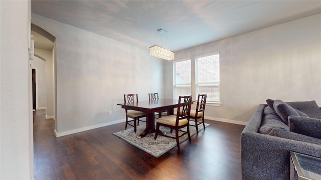 1916 Prestige Cove Ct, Wylie, TX 75098 - dining space featuring arched walkways, dark wood-style flooring, and baseboards