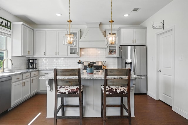5224 Sonata Trl, Fort Worth, TX 76126 - kitchen featuring appliances with stainless steel finishes, custom exhaust hood, dark wood-type flooring, a sink, and recessed lighting