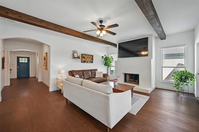 5224 Sonata Trl, Fort Worth, TX 76126 - living area with beamed ceiling, ceiling fan, dark wood-style floors, a brick fireplace, and baseboards