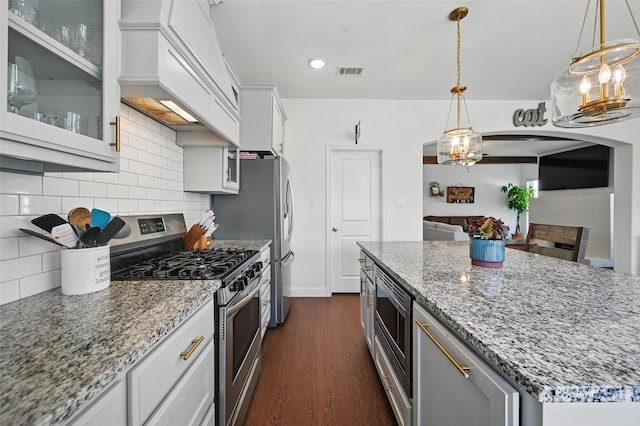 5224 Sonata Trl, Fort Worth, TX 76126 - kitchen featuring stainless steel appliances, decorative backsplash, dark wood finished floors, glass insert cabinets, and light stone counters