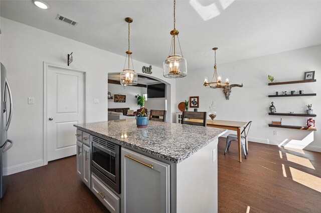 5224 Sonata Trl, Fort Worth, TX 76126 - kitchen with appliances with stainless steel finishes, dark wood-style floors, light stone countertops, a kitchen island, and baseboards