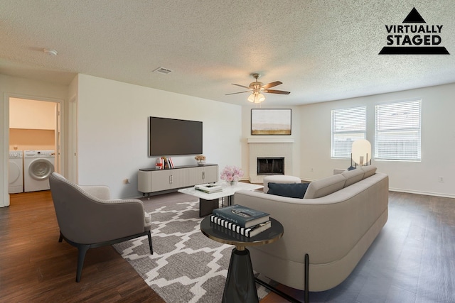 1423 Queen Annes Dr, Burleson, TX 76028 - living room featuring separate washer and dryer, ceiling fan, a fireplace, wood finished floors, and a textured ceiling