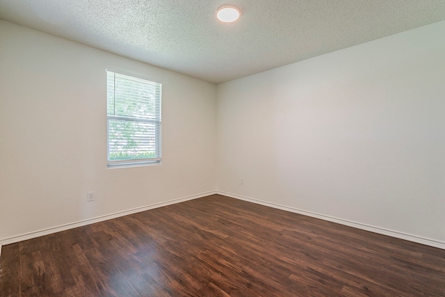 1423 Queen Annes Dr, Burleson, TX 76028 - spare room featuring dark wood-type flooring, baseboards, and a textured ceiling