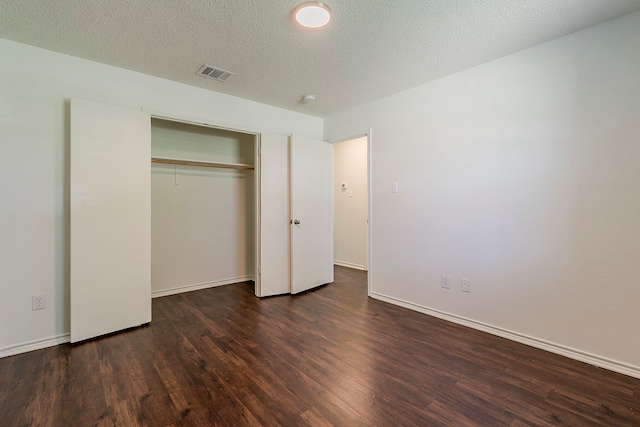 1423 Queen Annes Dr, Burleson, TX 76028 - unfurnished bedroom with wood finished floors, a closet, baseboards, and a textured ceiling