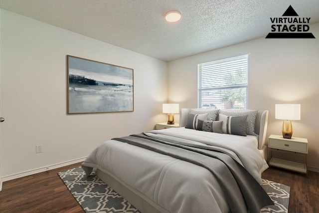 1423 Queen Annes Dr, Burleson, TX 76028 - bedroom featuring a textured ceiling, wood finished floors, and baseboards